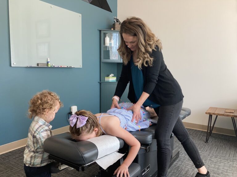 Dr. Danielle Pettet, a chiropractor specializing in pediatric, prenatal and postnatal care providing pediatric chiropractic adjustments to children who