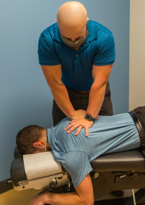 Sports chiropractor in Bellingham performing an adjustment on a face down patient to relieve back pain